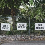 A fence with signs on it.