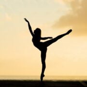 A silhouette of a ballerina performing at sunset.