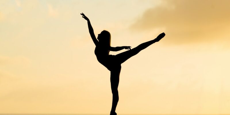 A silhouette of a ballerina performing at sunset.