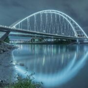 A bridge over a river at night.