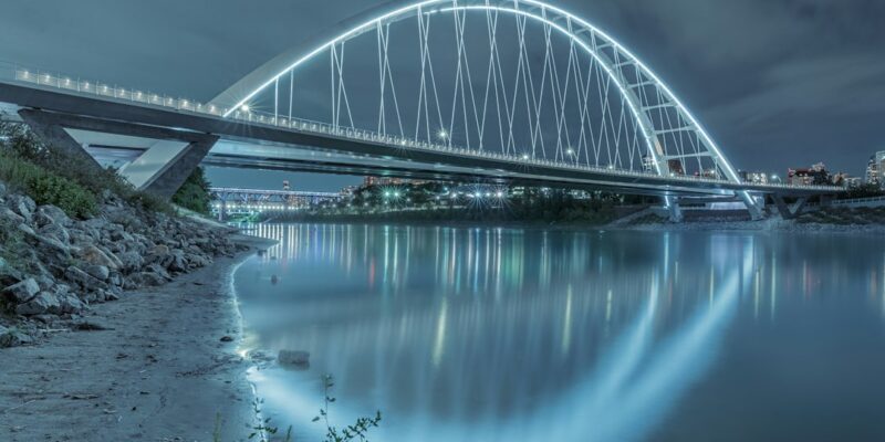 A bridge over a river at night.