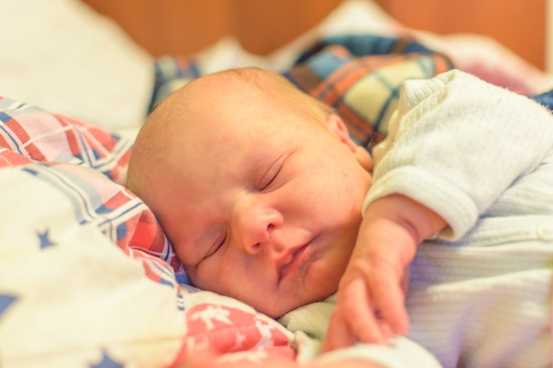 A baby sleeping on a blanket.