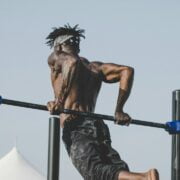 A man doing a pull up on a bar.