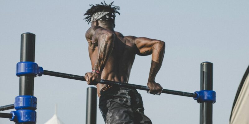 A man doing a pull up on a bar.