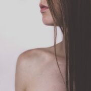 A close up of a woman with long brown hair.