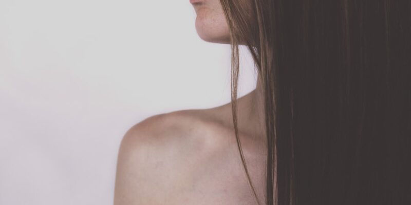 A close up of a woman with long brown hair.