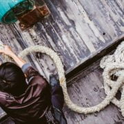 A man is pulling a rope on a boat.