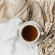 A cup of tea on a white cloth.