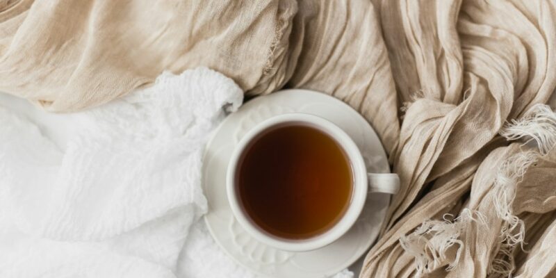 A cup of tea on a white cloth.