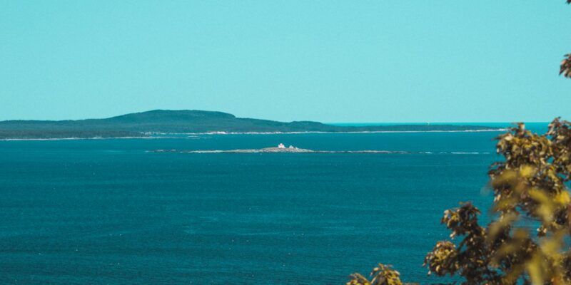 A small island in the middle of a large body of water.