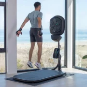 A man jumping on a liteboxer fitness bundle treadmill.