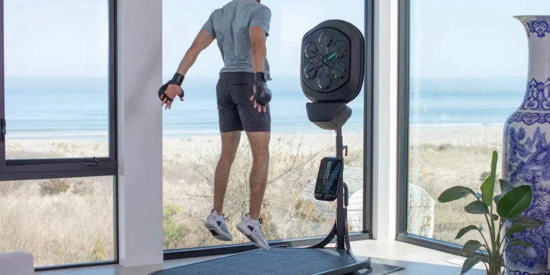 A man jumping on a liteboxer fitness bundle treadmill.