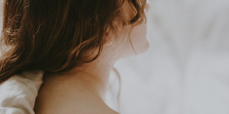 A girl with a mental health-related bird tattoo on her back.