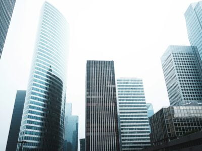 Modern skyscrapers reaching into an overcast sky in a bustling city's business district.