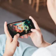 Woman playing a colorful mobile game on her smartphone.