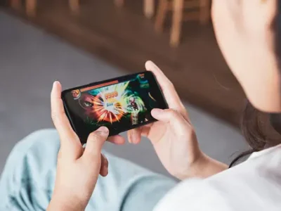 Woman playing a colorful mobile game on her smartphone.