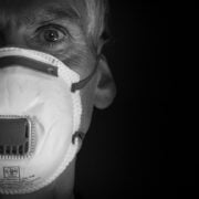 A man wearing a face mask in black and white.