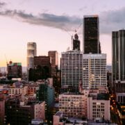 Downtown los angeles skyline at dusk with towering skyscrapers and a colorful sky.