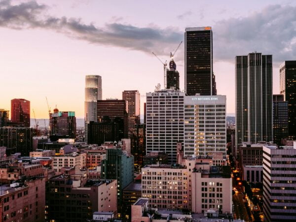 Downtown los angeles skyline at dusk with towering skyscrapers and a colorful sky.