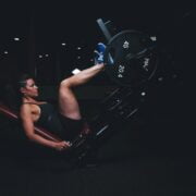 A woman doing morning leg exercises in a gym.