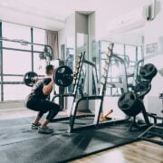 A man doing leg exercises in a gym in the morning.