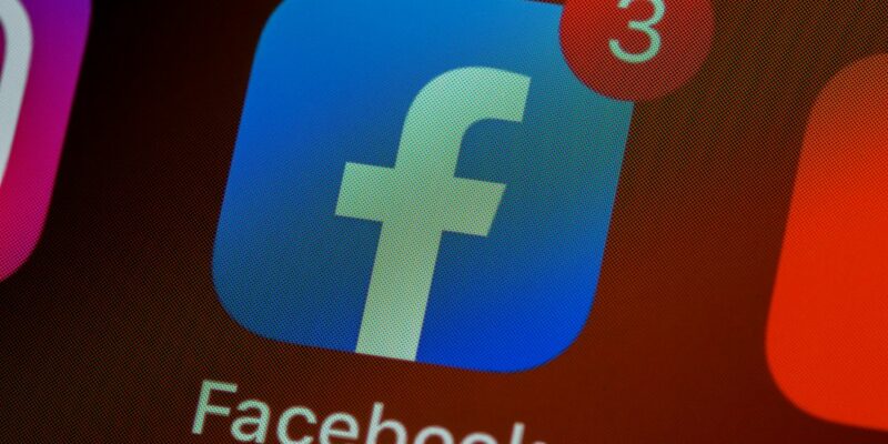 The Facebook logo, often questioned during outages on why Facebook is down, is displayed on a cell phone, reminding us why we should not panic to avoid health issues.