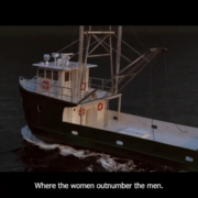 A small fishing boat sails on the ocean at dusk. The text "Where the women outnumber the men" is displayed at the bottom of the image.