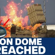 Image depicting an Iron Dome system intercepting multiple projectiles. The headline reads "Iron Dome Breached" with news channel branding on the side.