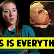 A woman with long brown hair, wearing a turquoise sweater, gesturing while speaking. Next to her, an inset image shows a person in a white mask holding another person's face closely. The words "THIS IS EVERYTHING" are in bold yellow below both images.