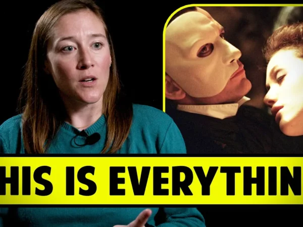 A woman with long brown hair, wearing a turquoise sweater, gesturing while speaking. Next to her, an inset image shows a person in a white mask holding another person's face closely. The words "THIS IS EVERYTHING" are in bold yellow below both images.