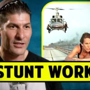 Man speaking with an image of a stunt scene involving helicopters in the background. Text reads "Stunt Work".