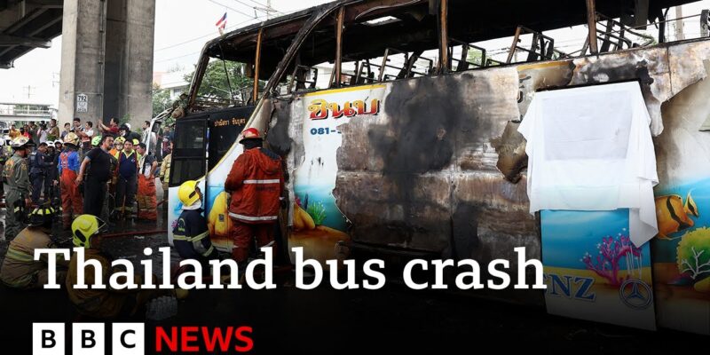 Firefighters and rescue workers surround a severely burnt bus in Thailand after a crash.